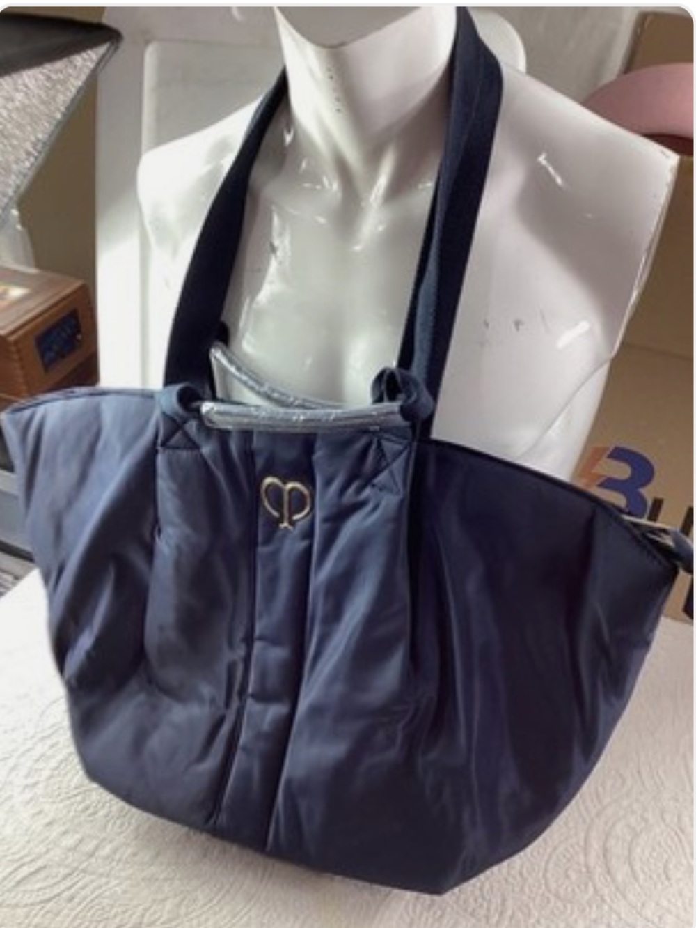 cle de peau Navy Quilted Tote with Black Straps and Gold Emblem